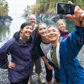 Family taking a group selfie outdoors
