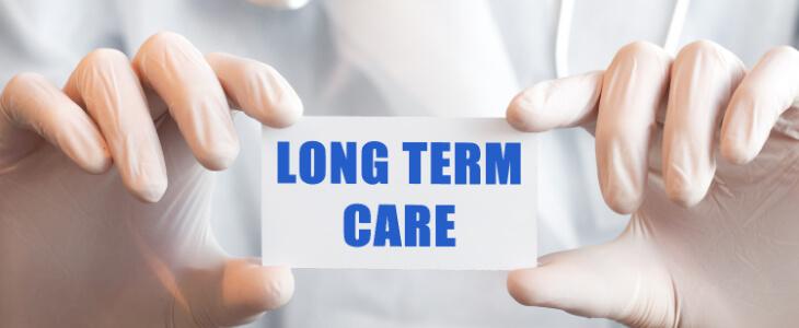 image of hands holding a printout of the words long term care