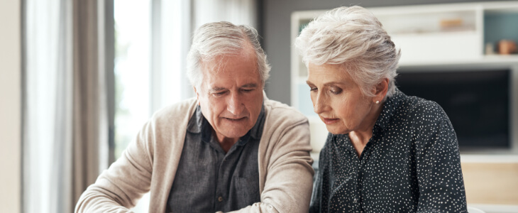 older man and woman looking at papers trust and estate planning